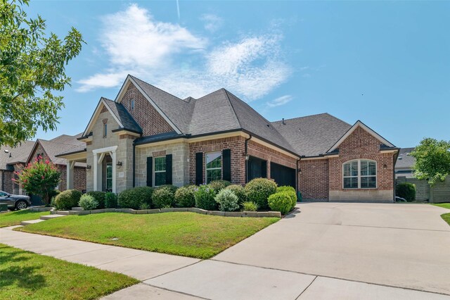 view of front facade with a front lawn and a garage