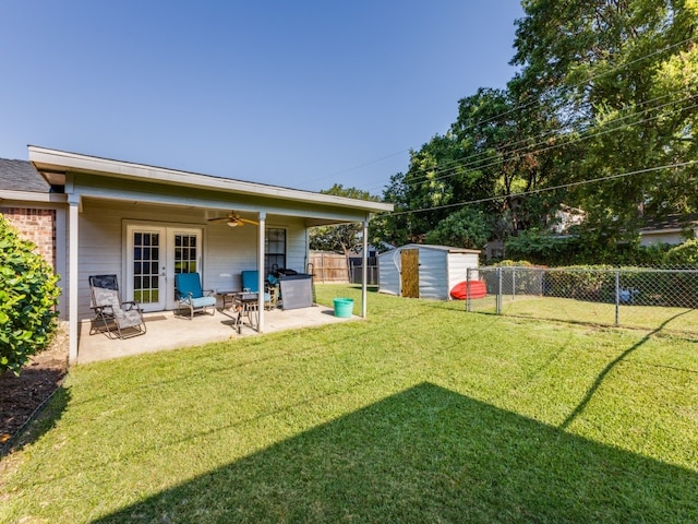 view of yard with a patio area, ceiling fan, and a storage unit