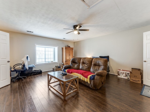 living room featuring ceiling fan and dark hardwood / wood-style floors