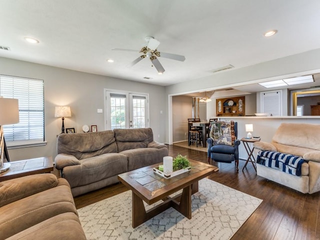 living room featuring dark hardwood / wood-style floors, ceiling fan, and french doors