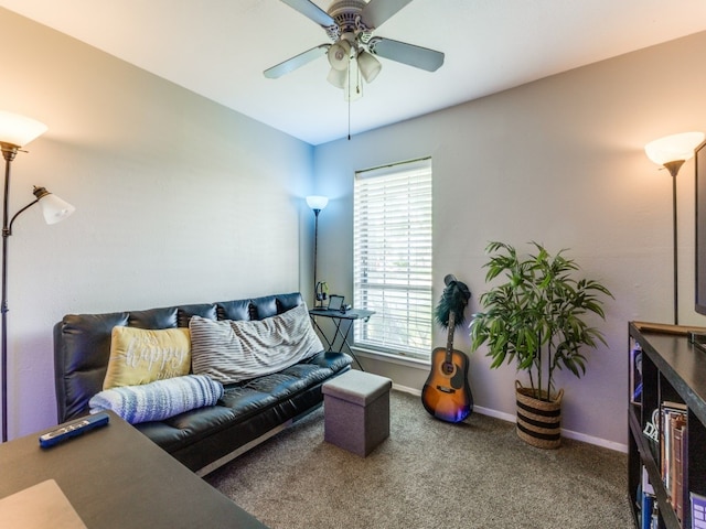 living room with ceiling fan and carpet