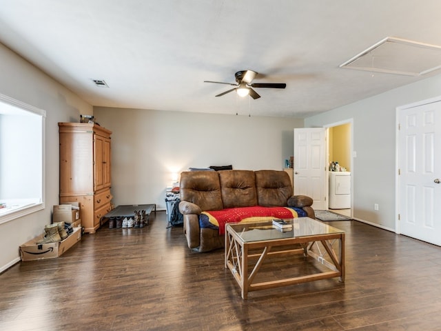 living room with washer / dryer, ceiling fan, and dark hardwood / wood-style flooring