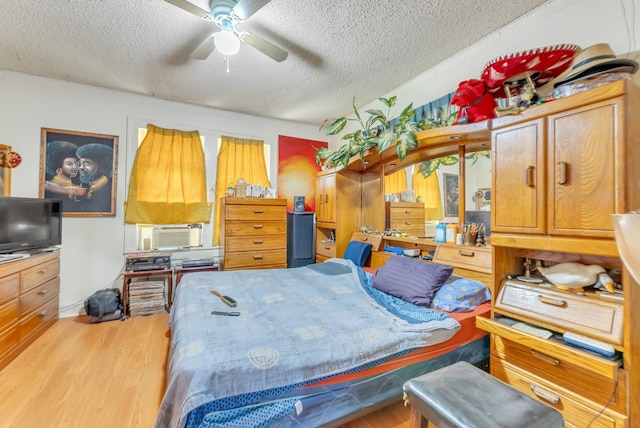 bedroom featuring light hardwood / wood-style flooring and a textured ceiling