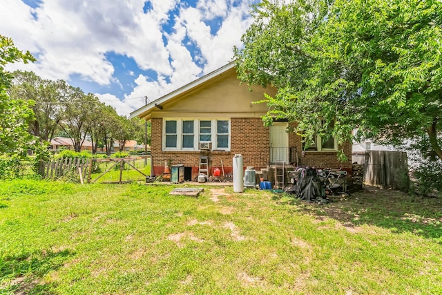 rear view of property with a yard