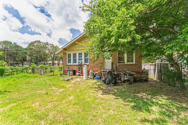 back of property featuring a lawn