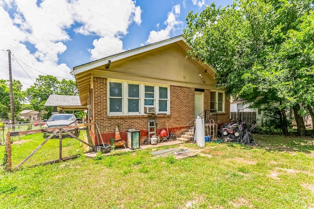 rear view of property featuring a yard