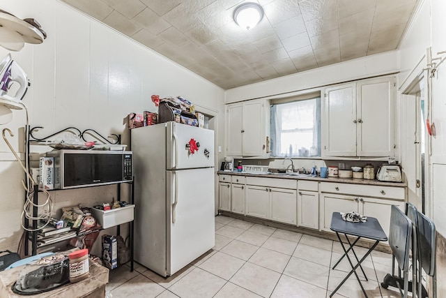 kitchen featuring sink, white cabinets, and white refrigerator