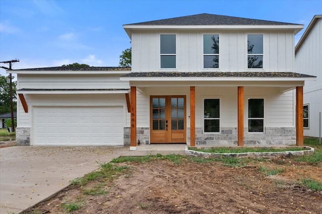 view of front of home featuring a porch and a garage