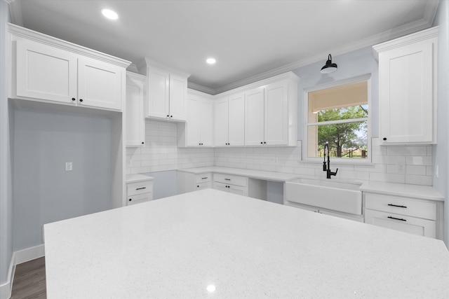 kitchen with white cabinets, sink, and decorative backsplash