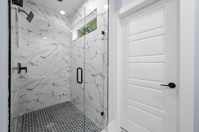 bathroom featuring a shower with door