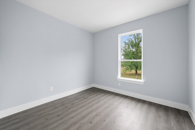 unfurnished room featuring a wealth of natural light and hardwood / wood-style floors