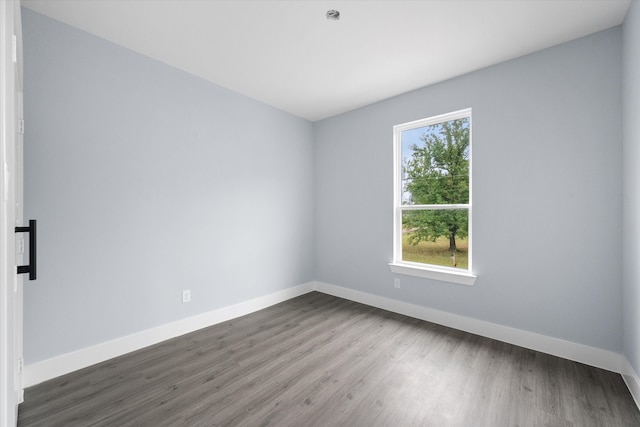 spare room with hardwood / wood-style floors