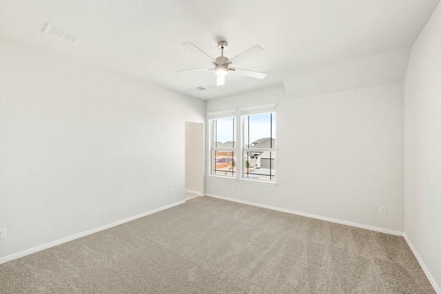 carpeted spare room with ceiling fan