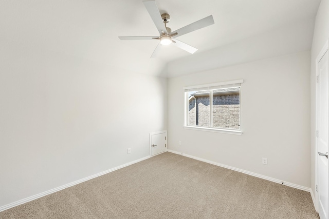 unfurnished room with lofted ceiling, ceiling fan, and carpet