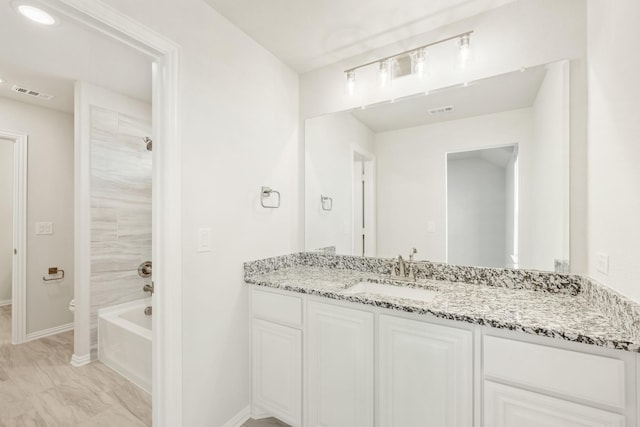 full bathroom with vanity, washtub / shower combination, and toilet