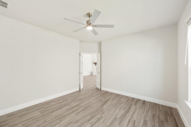 empty room featuring ceiling fan and light hardwood / wood-style flooring