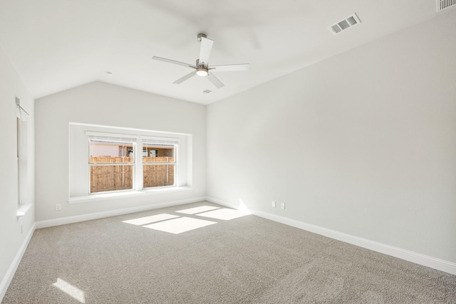 unfurnished room featuring vaulted ceiling, carpet flooring, and ceiling fan