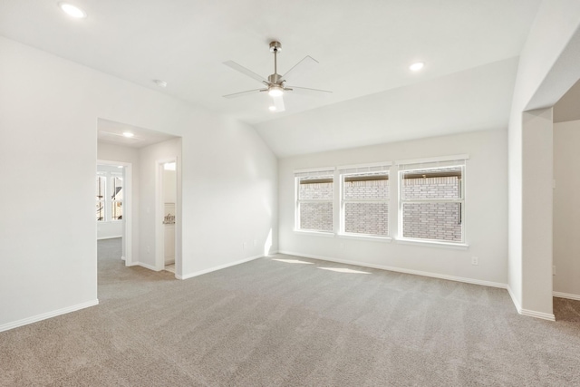 unfurnished living room with lofted ceiling, light colored carpet, and ceiling fan