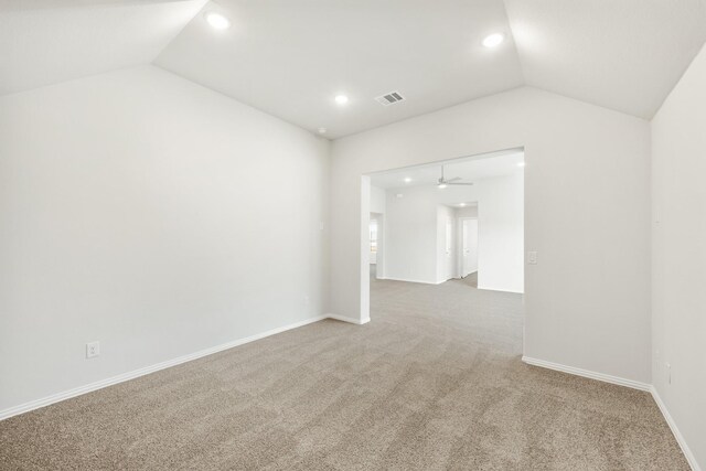 unfurnished room featuring vaulted ceiling and carpet