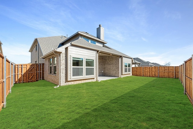 rear view of property featuring a lawn