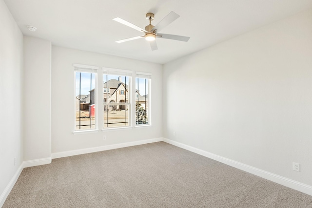 spare room with carpet floors and ceiling fan