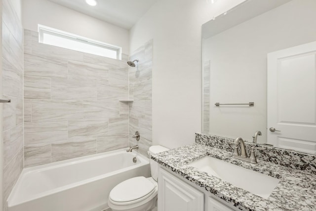 full bathroom featuring tiled shower / bath combo, vanity, and toilet