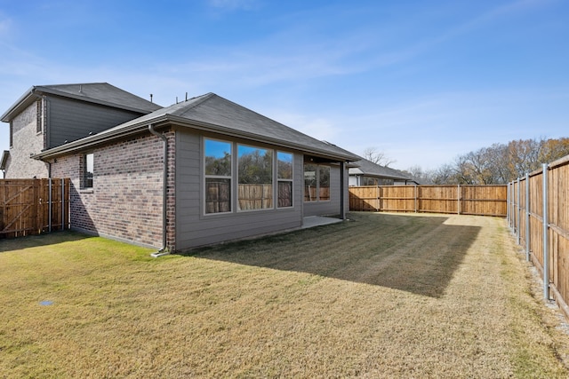 rear view of house with a lawn