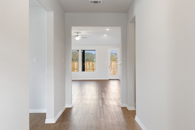 corridor with wood-type flooring