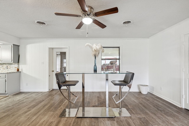 interior space featuring a textured ceiling, ceiling fan, and wood-type flooring