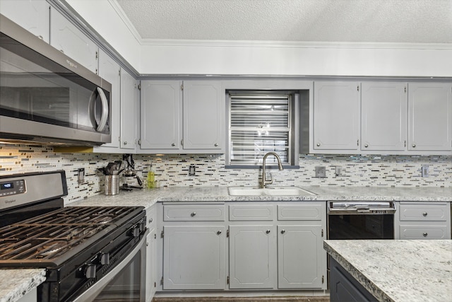 kitchen with backsplash, sink, stainless steel appliances, and crown molding