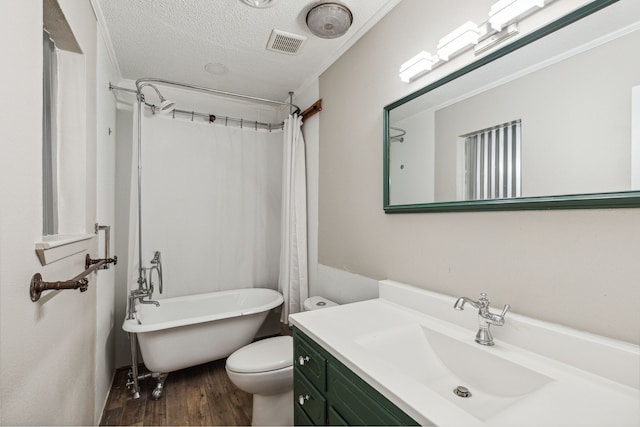 full bathroom with toilet, vanity, wood-type flooring, separate shower and tub, and a textured ceiling