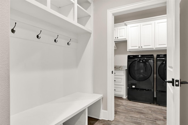 mudroom featuring light wood-style flooring and independent washer and dryer