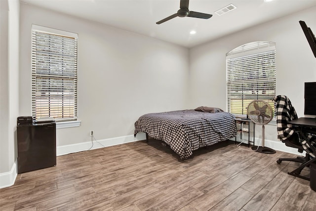 bedroom with baseboards, visible vents, ceiling fan, wood finished floors, and recessed lighting