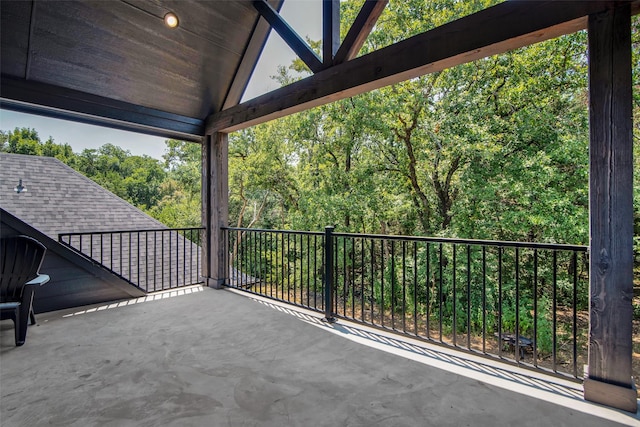 view of patio / terrace featuring a balcony and a forest view