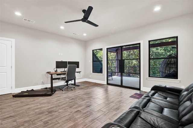 office featuring baseboards, visible vents, wood finished floors, and recessed lighting