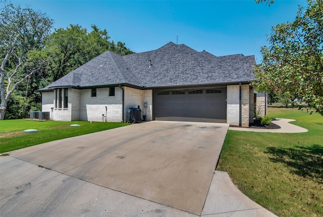 french country inspired facade featuring a garage, a shingled roof, brick siding, concrete driveway, and a front lawn