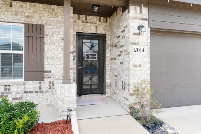 doorway to property with a garage