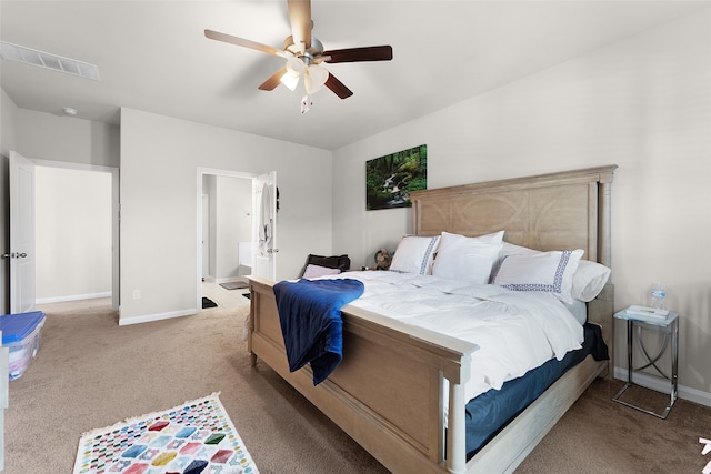 bedroom featuring light carpet, connected bathroom, and ceiling fan