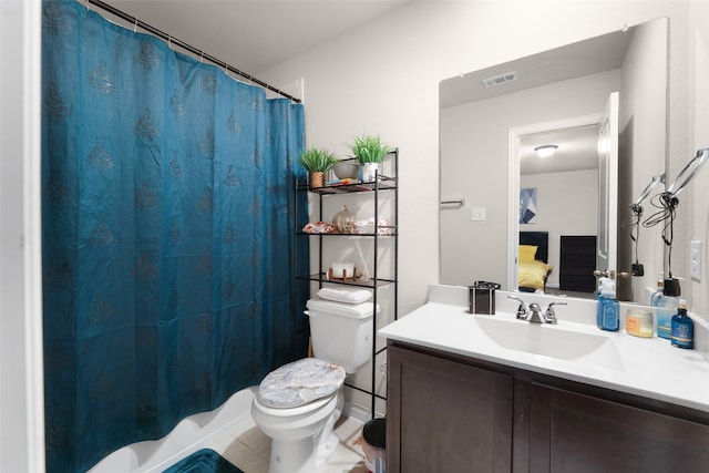 bathroom featuring vanity, toilet, and tile patterned floors