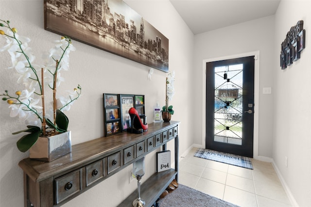 foyer entrance with light tile patterned flooring and a wealth of natural light