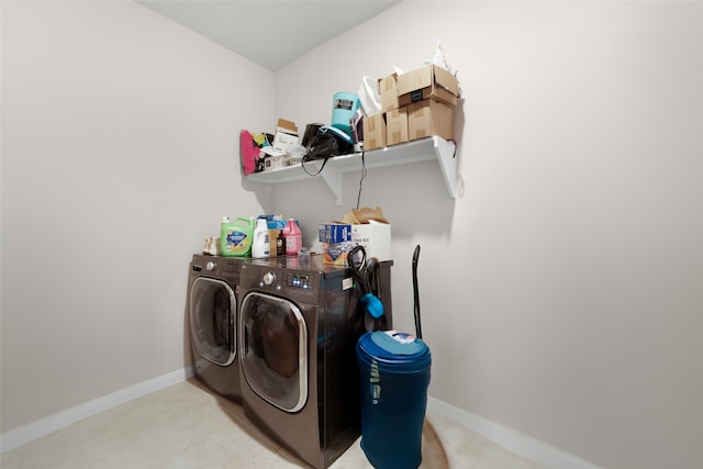 clothes washing area featuring light carpet and washer and clothes dryer