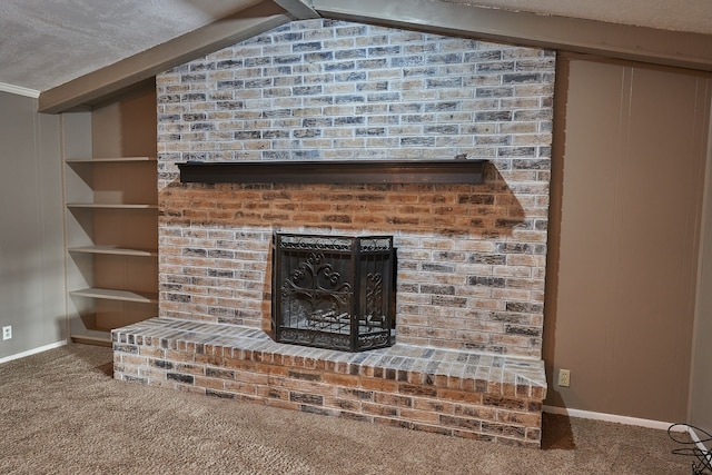 interior details featuring beamed ceiling, a brick fireplace, carpet floors, and a textured ceiling