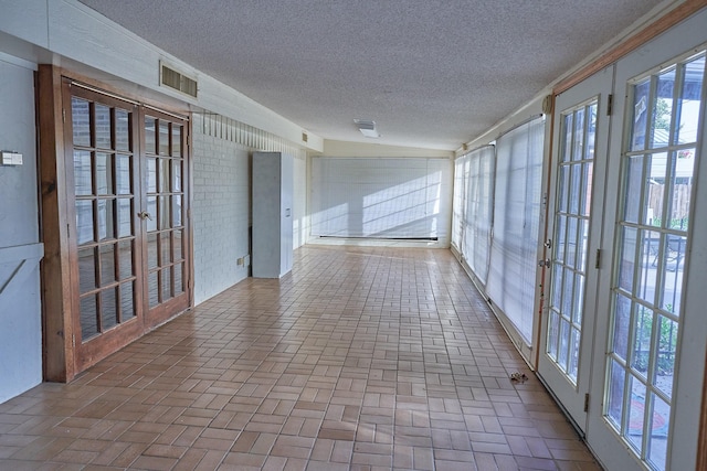 unfurnished sunroom featuring french doors