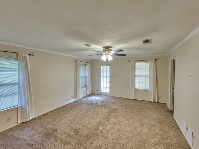 carpeted empty room with ornamental molding, a textured ceiling, and ceiling fan