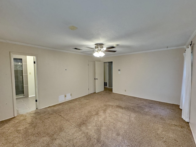 carpeted empty room featuring ceiling fan and ornamental molding