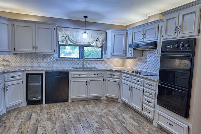 kitchen featuring sink, decorative backsplash, exhaust hood, and black appliances