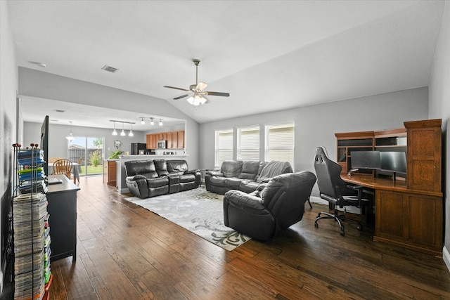 living room with dark hardwood / wood-style flooring, rail lighting, ceiling fan, and vaulted ceiling