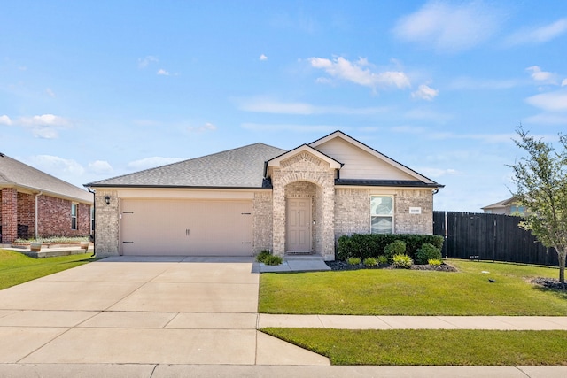 ranch-style house featuring a garage and a front lawn