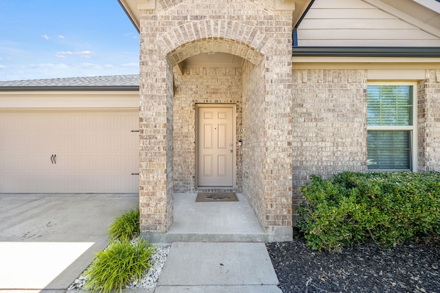 view of exterior entry featuring a garage