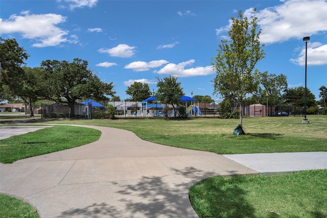 view of home's community with a lawn and a playground